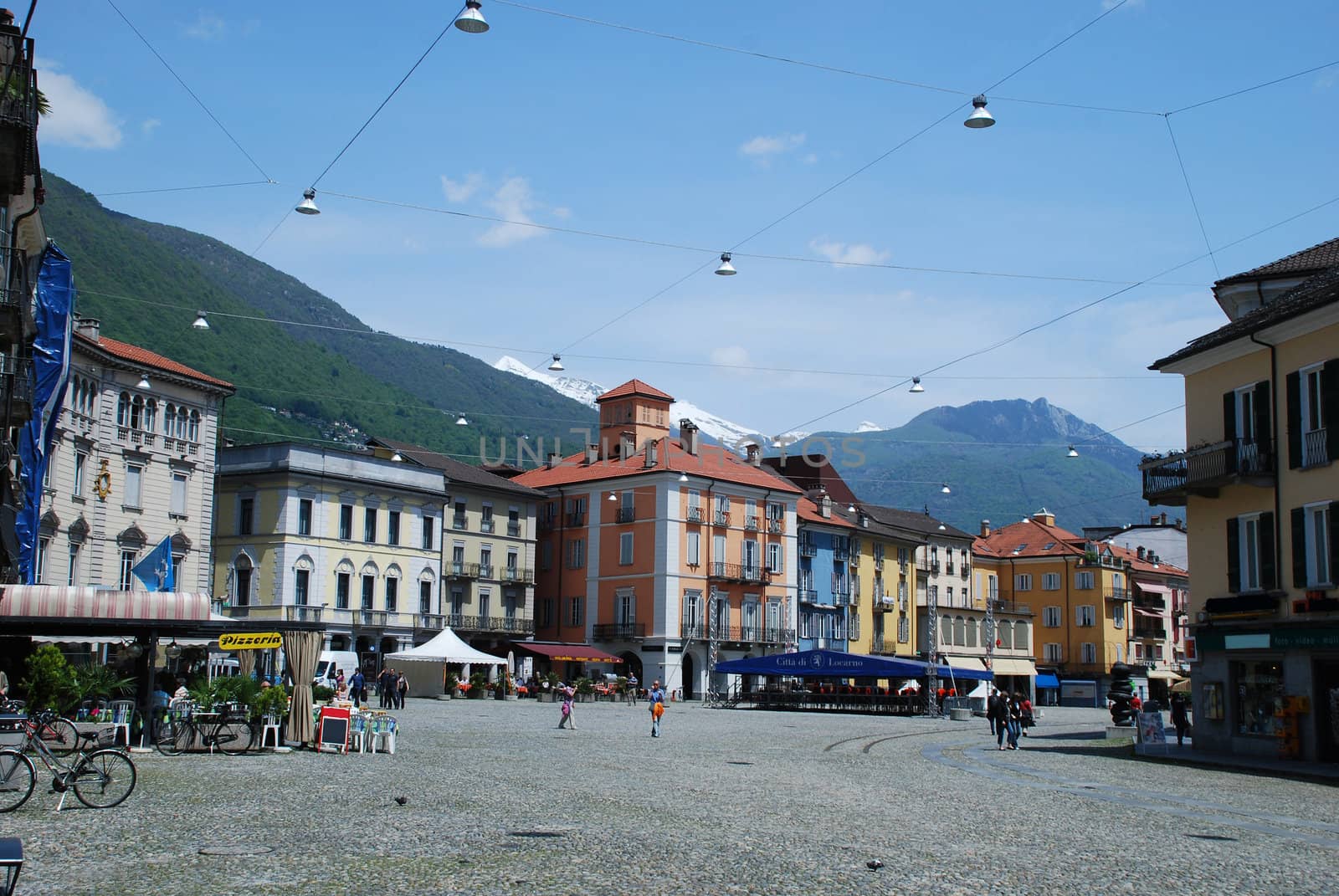 In the city center of Lucarno the Piazza grande is nice wolking place, there are restaurantes and bars, shops.  In back side we can see alp mountains still snow covered in spite of end of May