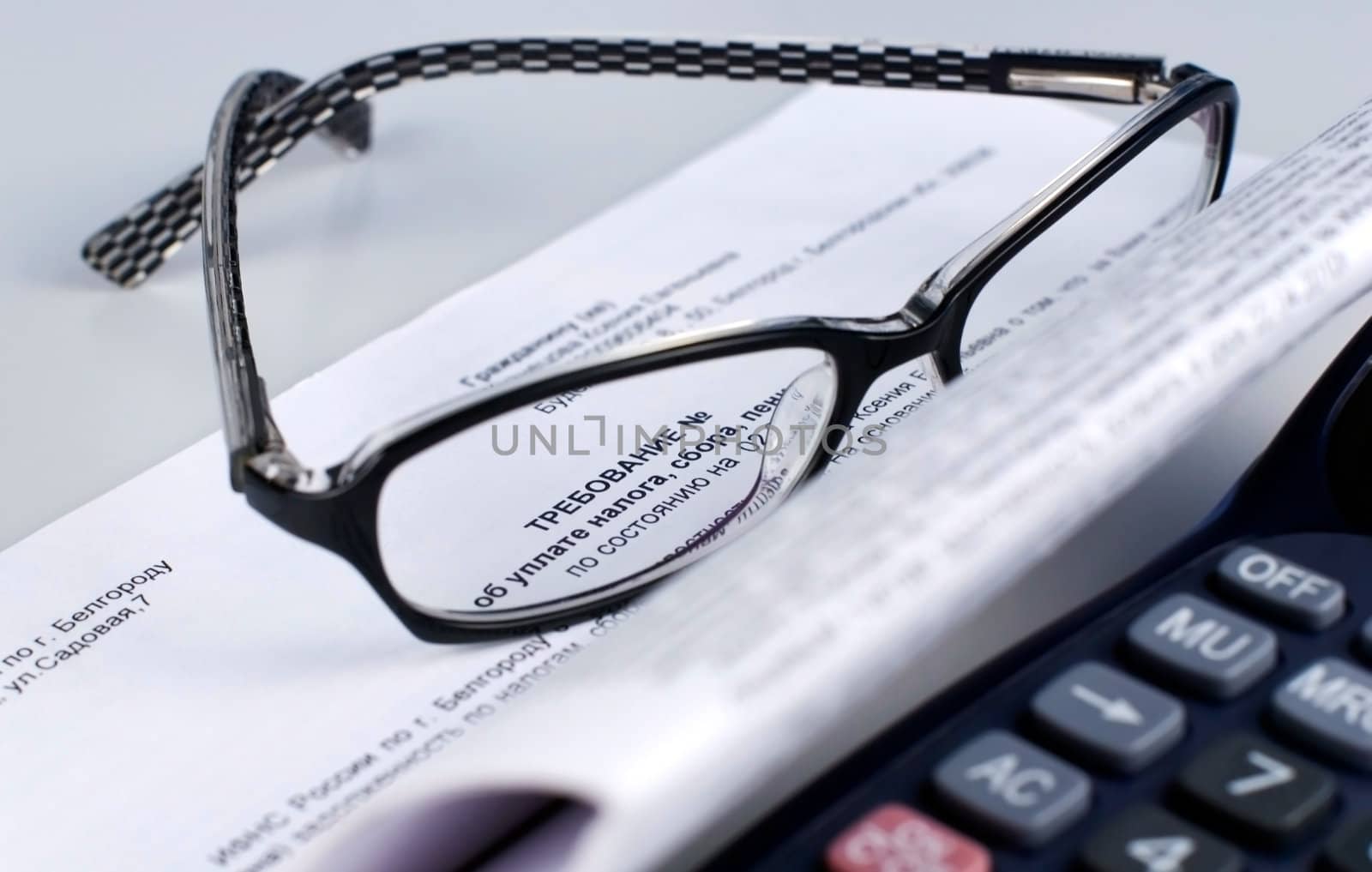 tax document with  calculator and glasses