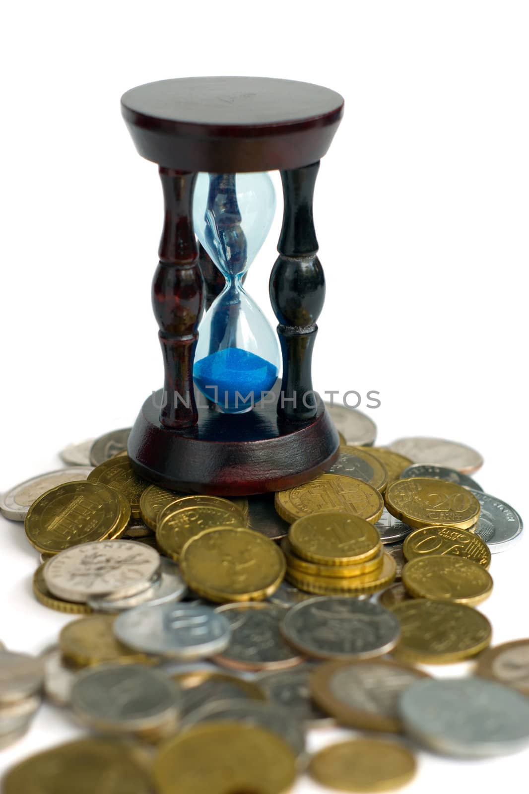 Time is money - sandglass and coins