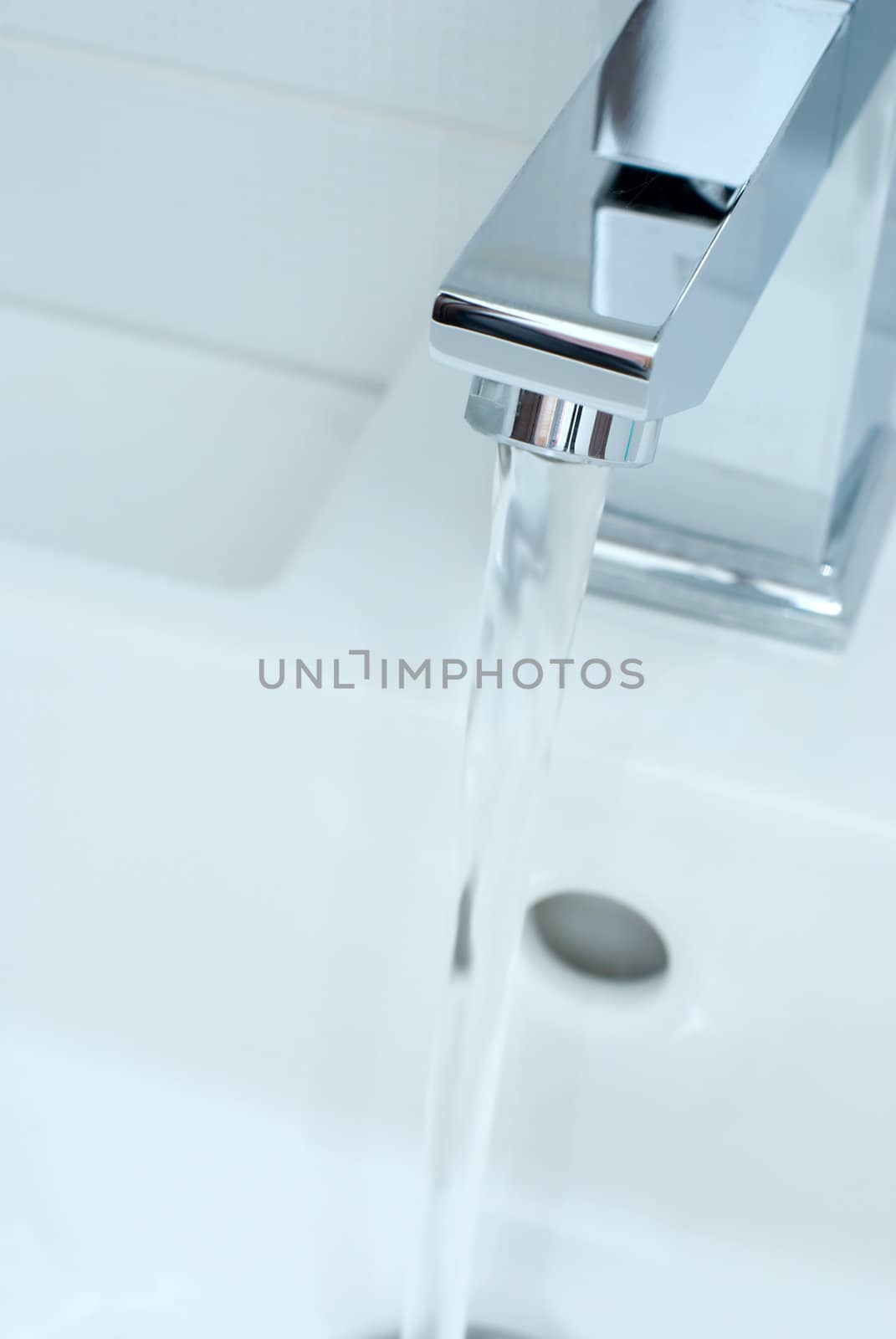 Closeup of modern bathroom tap in blue