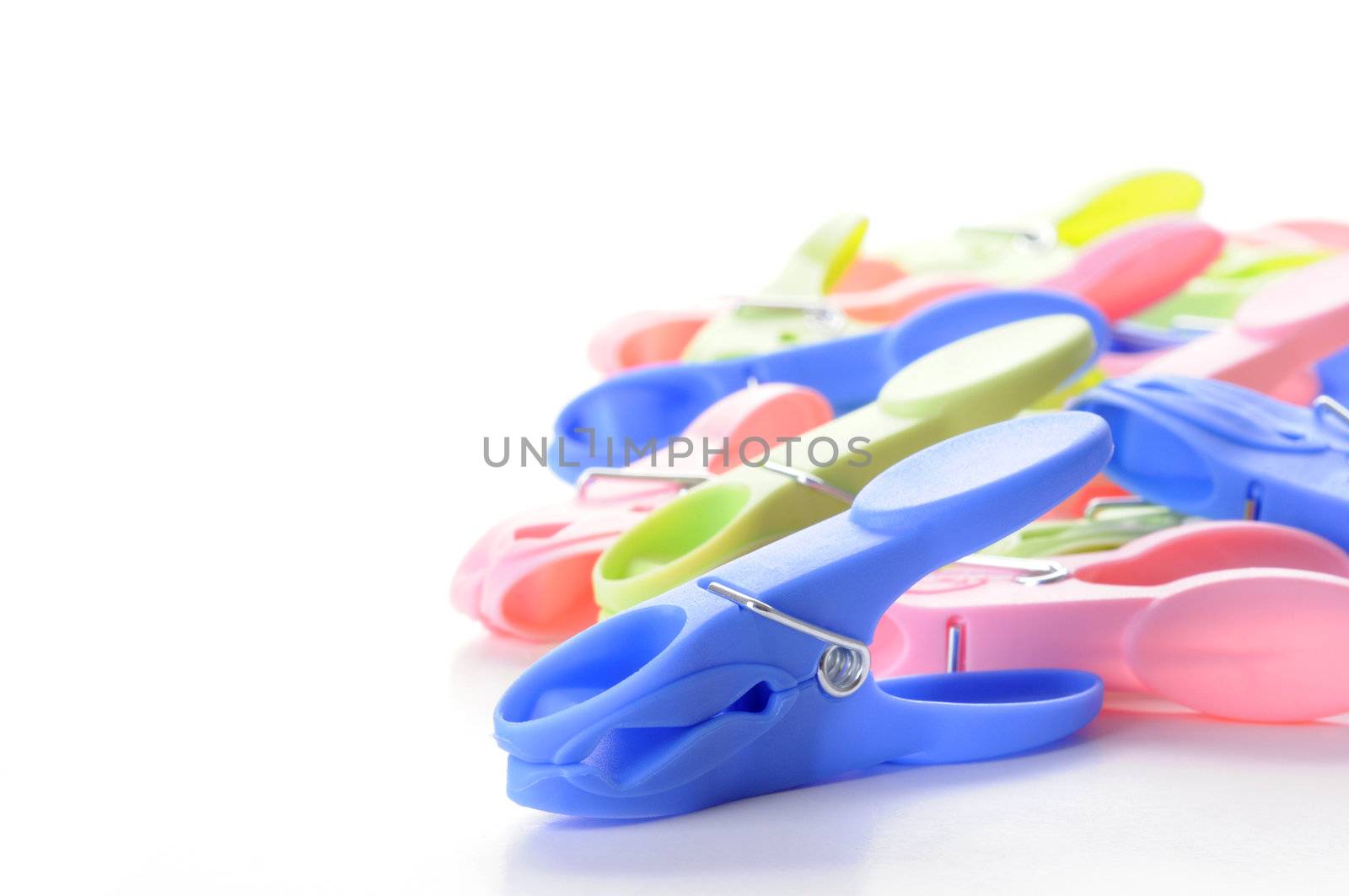Closeup of colorful plastic clothespins with room for text.
