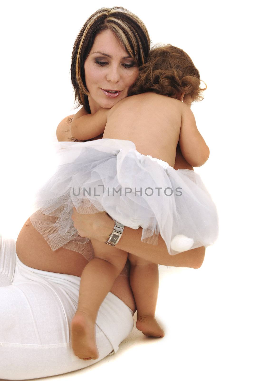 beautiful pregnant topless mother playing with her infant daughter