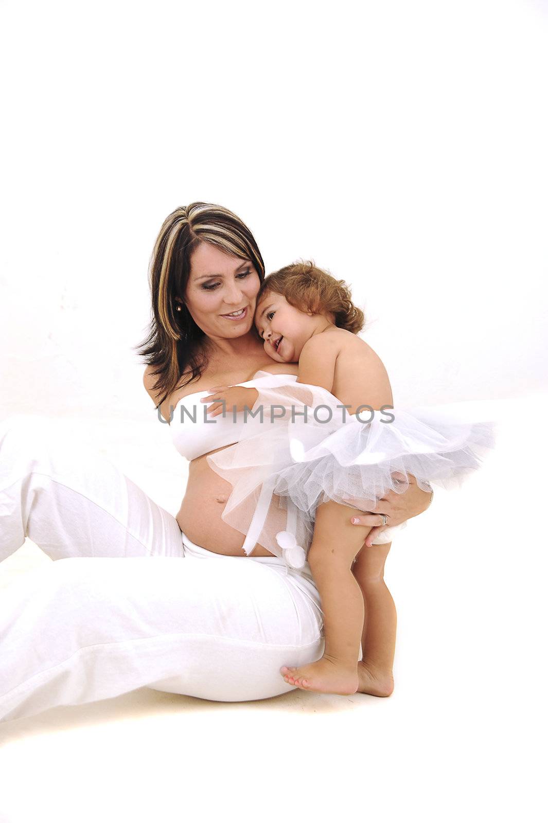 beautiful pregnant topless mother playing with her infant daughter