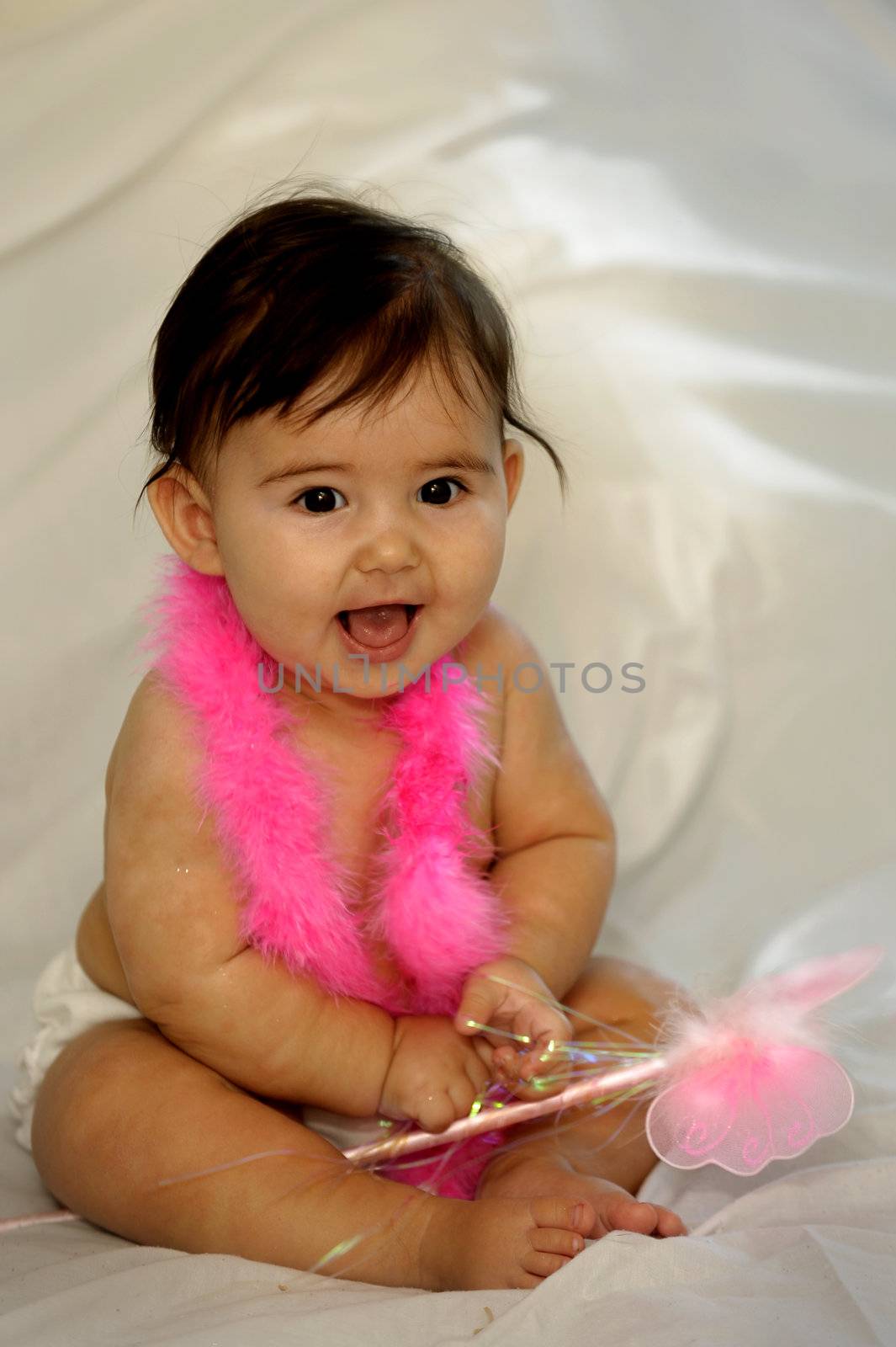 naked baby sitting and smiling with pink feathers holding a butterfly wand by Ansunette