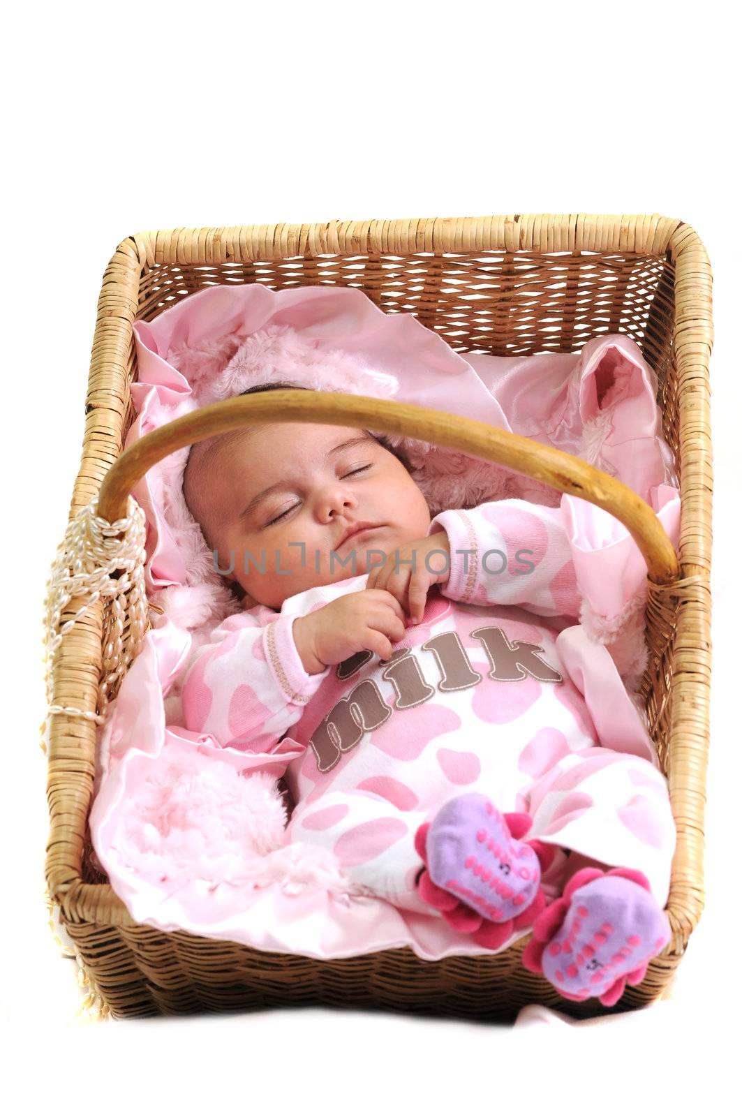 baby girl in pink laying in a brown basket draped with white beads by Ansunette