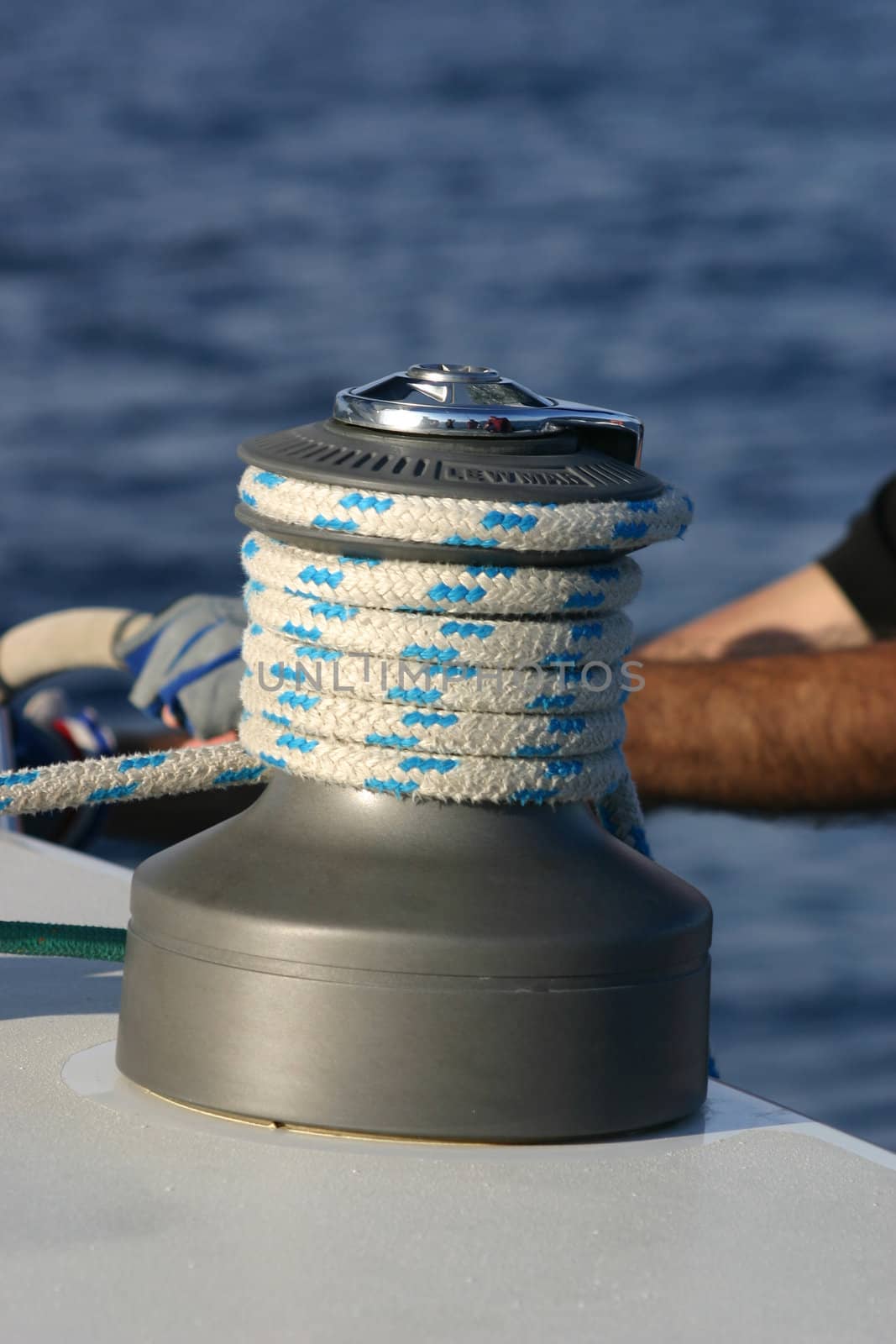 modern winch and rope with a man's arm behind