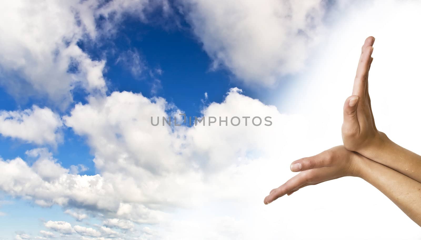 Hands on blue sky background. Women's hands supporting the blue clear sky.