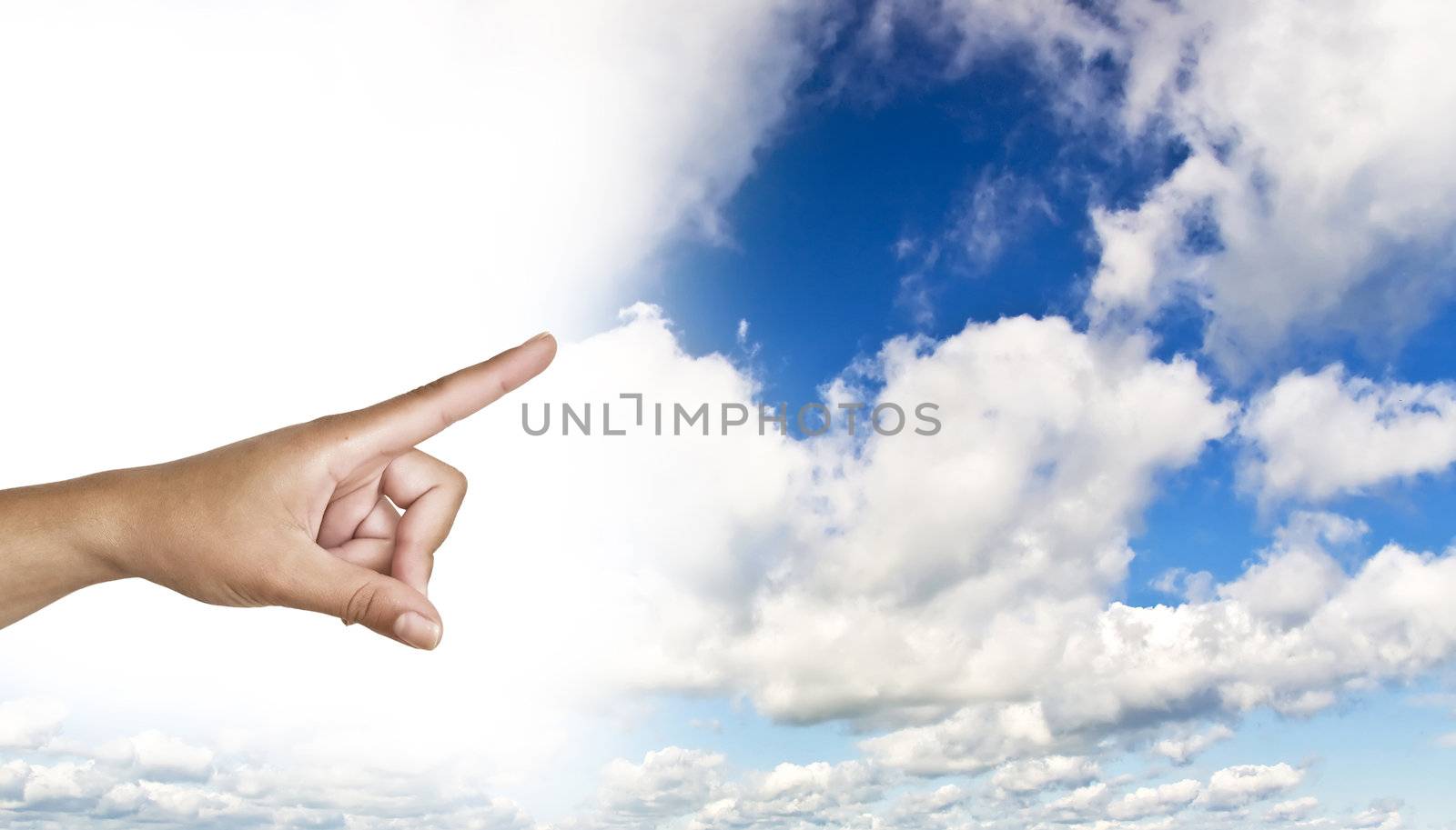 hand on the blue clear sky. Woman's hand with index finger.