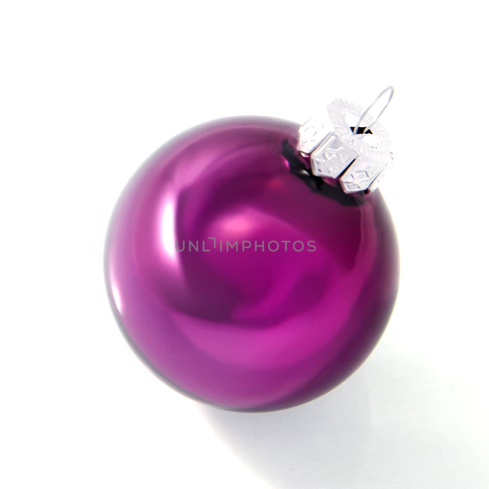 a pink christmas ball on a white background