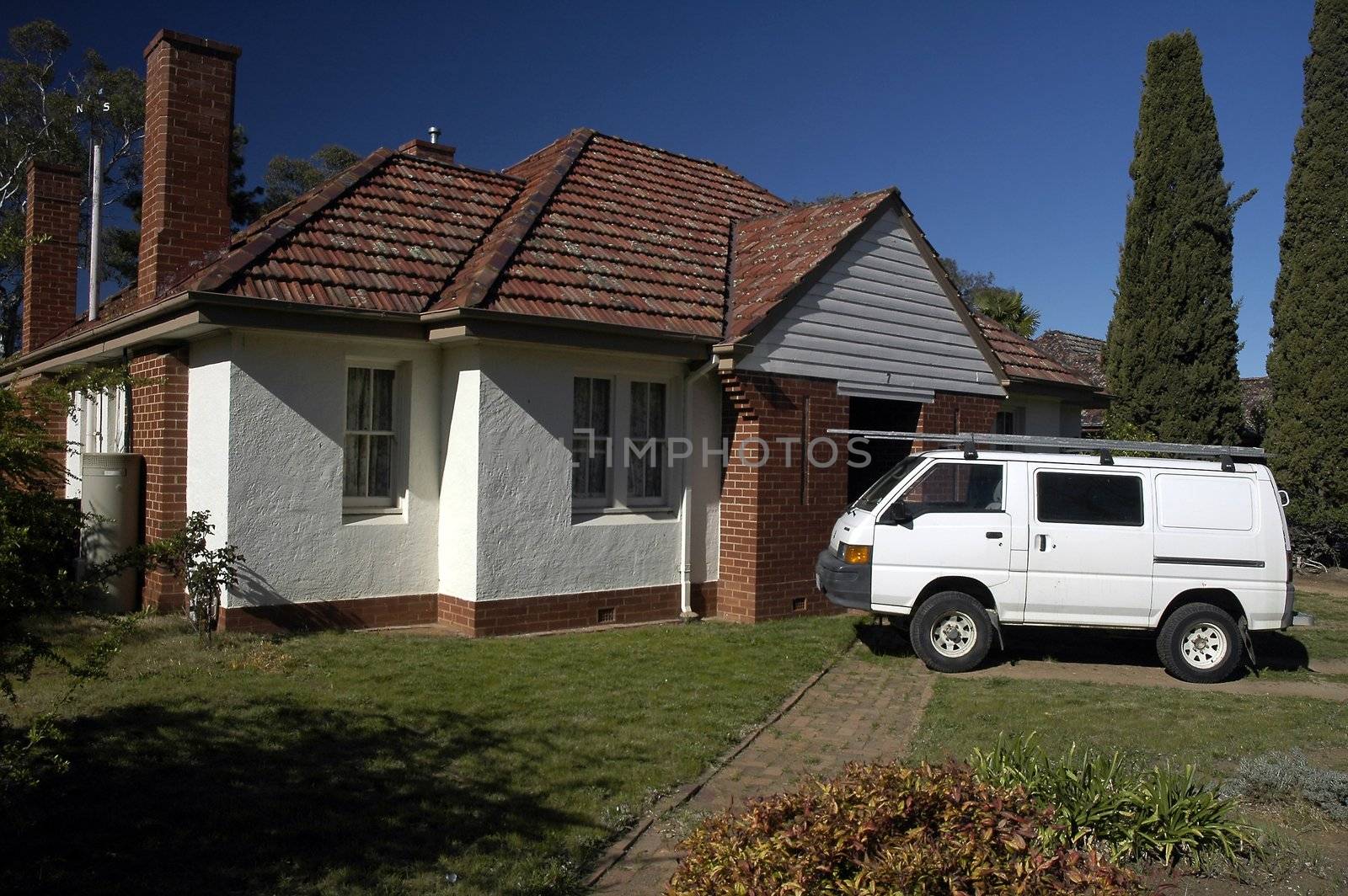 small australian typical house, white van in front of it