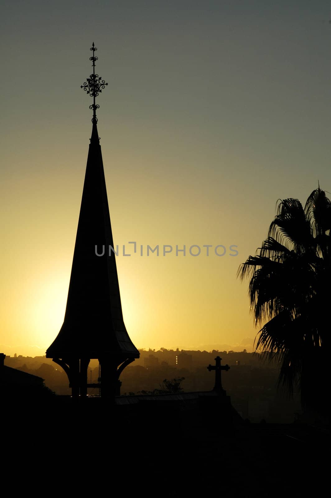 church and palm silhouette, yellow sky - sunset