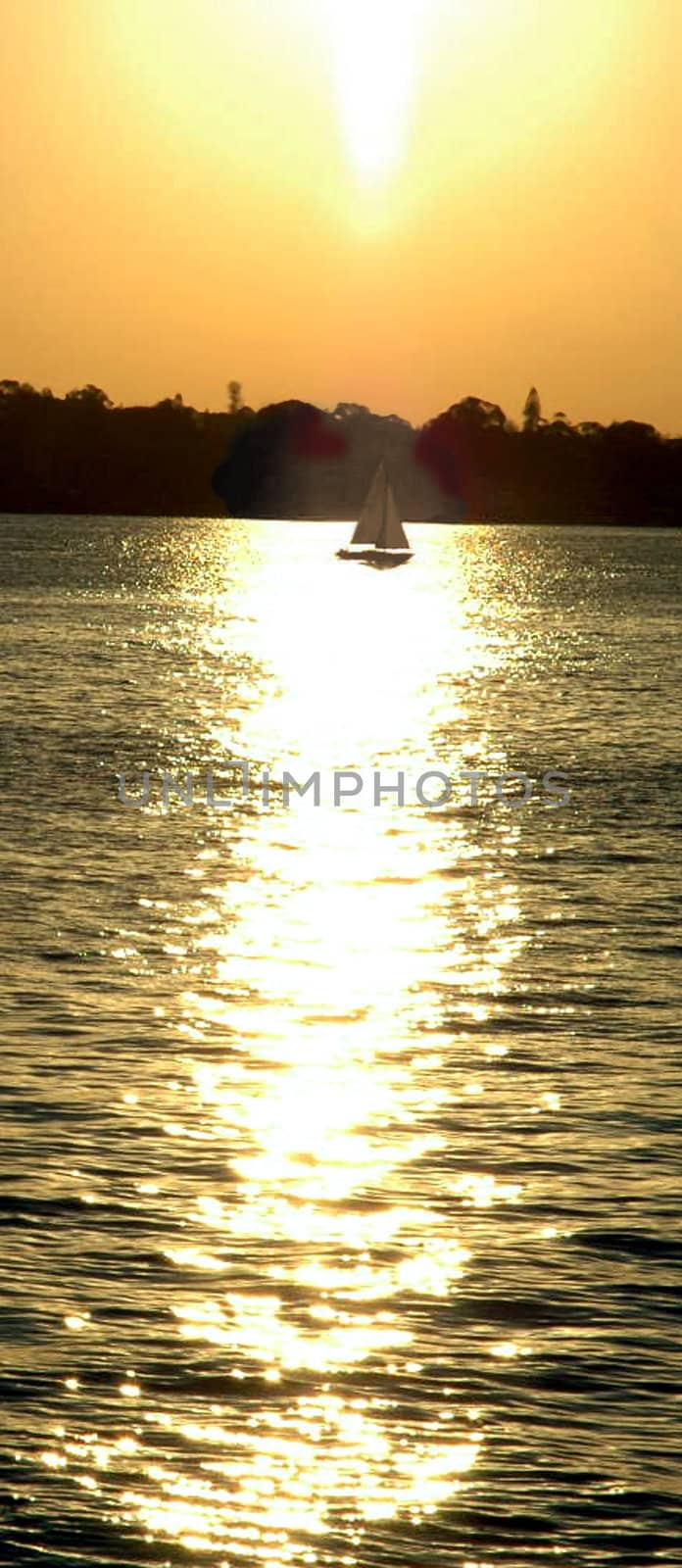 vertical photo of a small boat, sun reflection