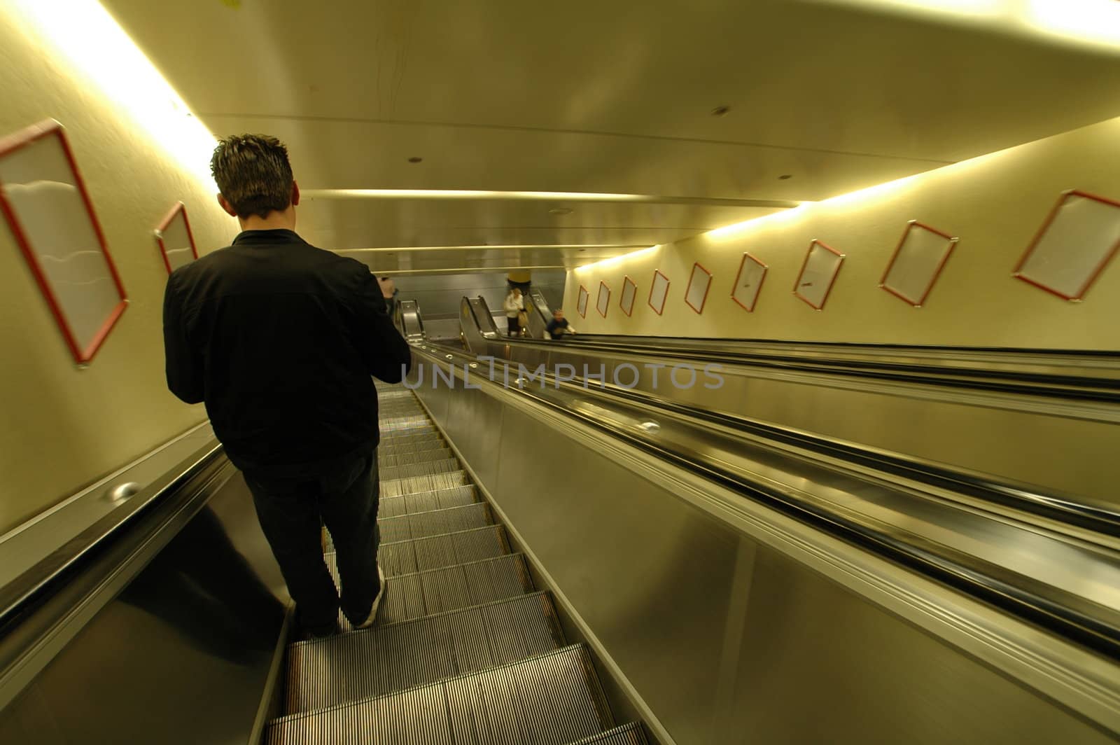 solitary man going down on an escalator (original)