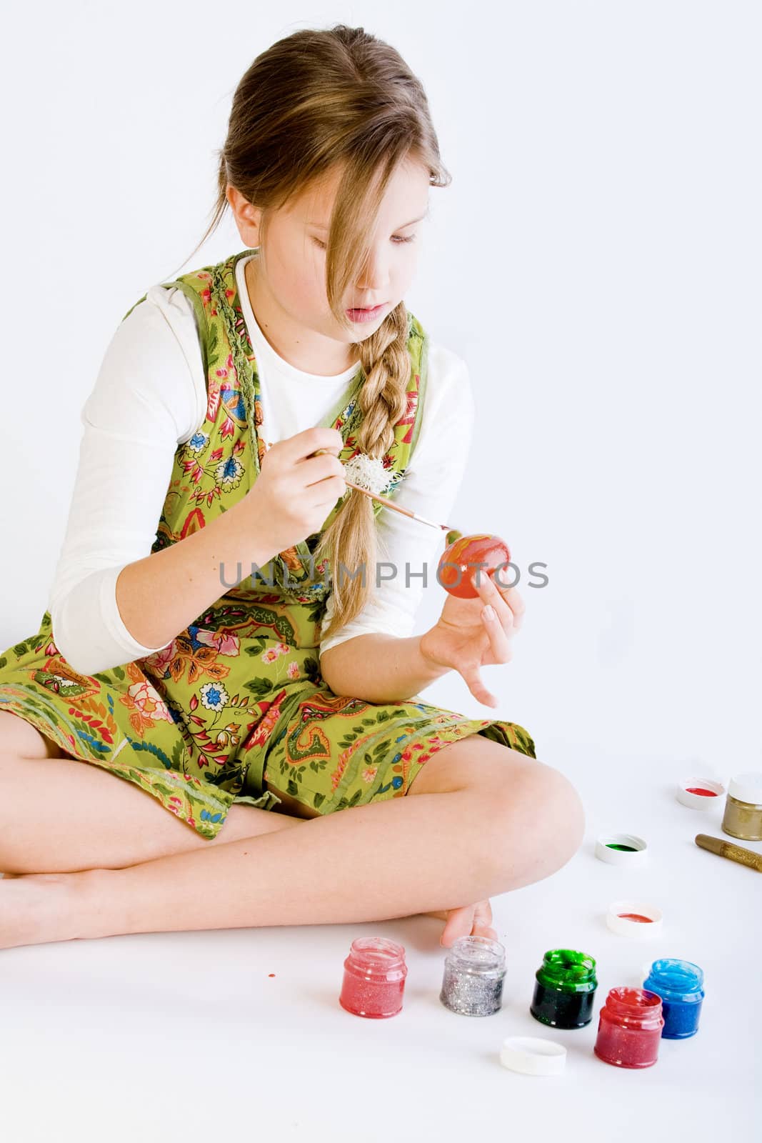 Young girl painting her easter eggs by DNFStyle