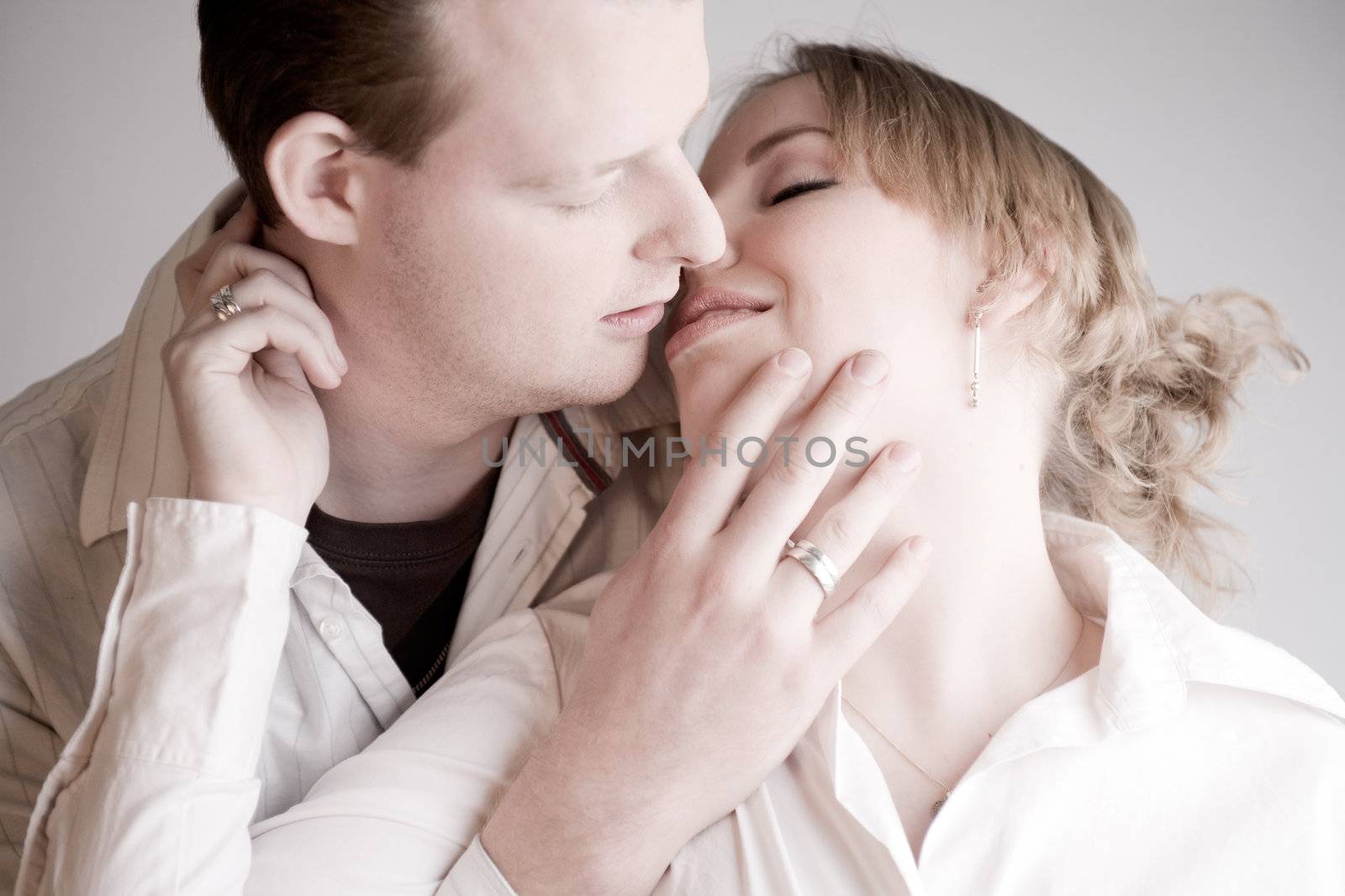 Studio portrait of a young amorous couple kissing
