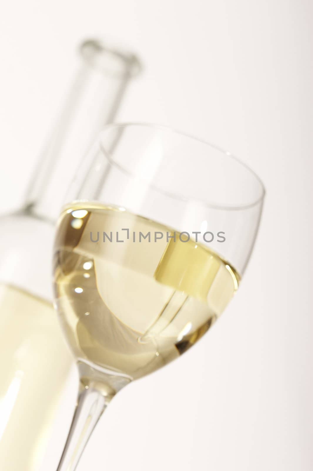 glass of white wine on the blurred bottle background