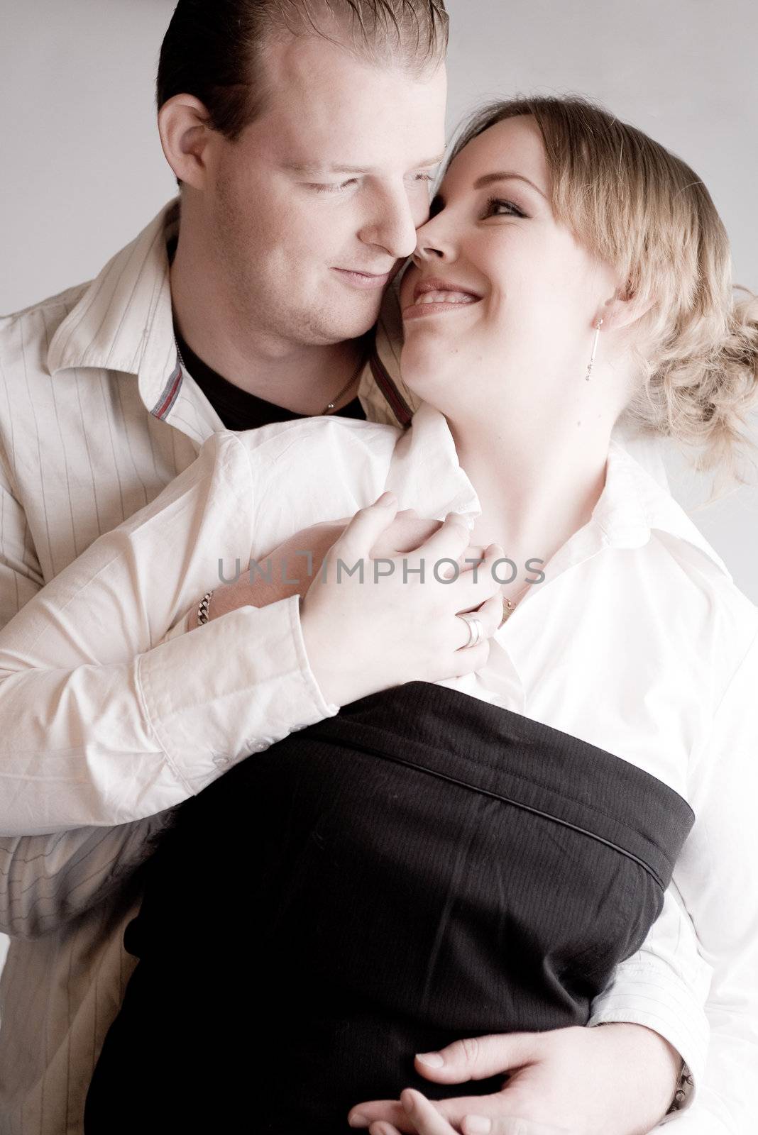 Studio portrait of a young amorous couple holding hands