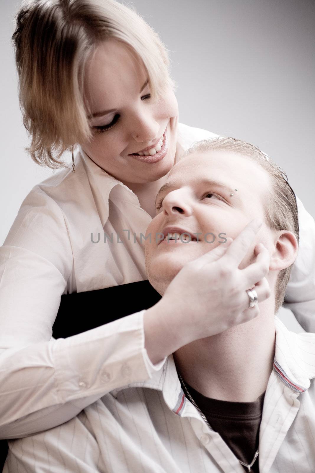 Studio portrait of a young amorous couple touching