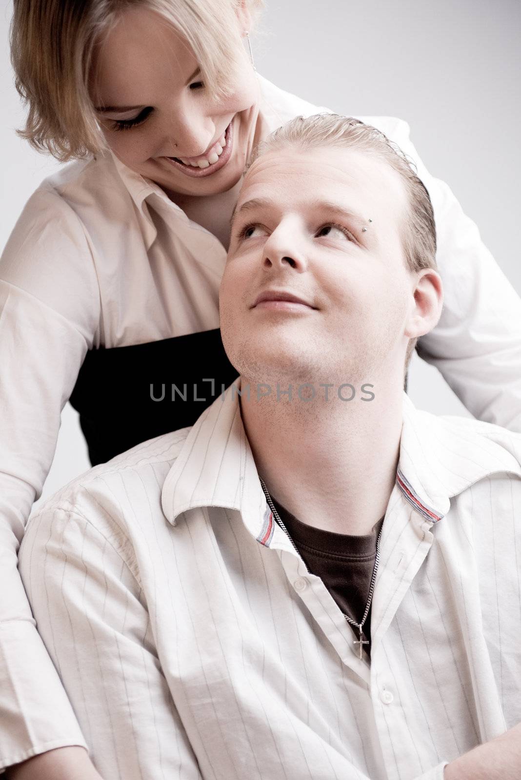 Studio portrait of a young amorous couple making eye contact with eachother