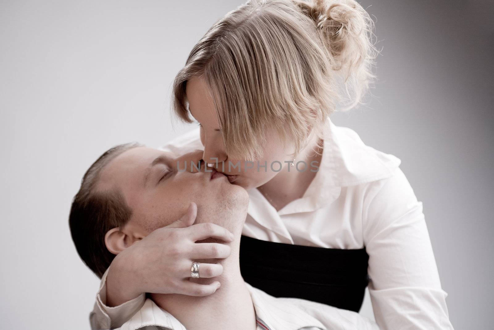 Studio portrait of a young amorous couple being passionate
