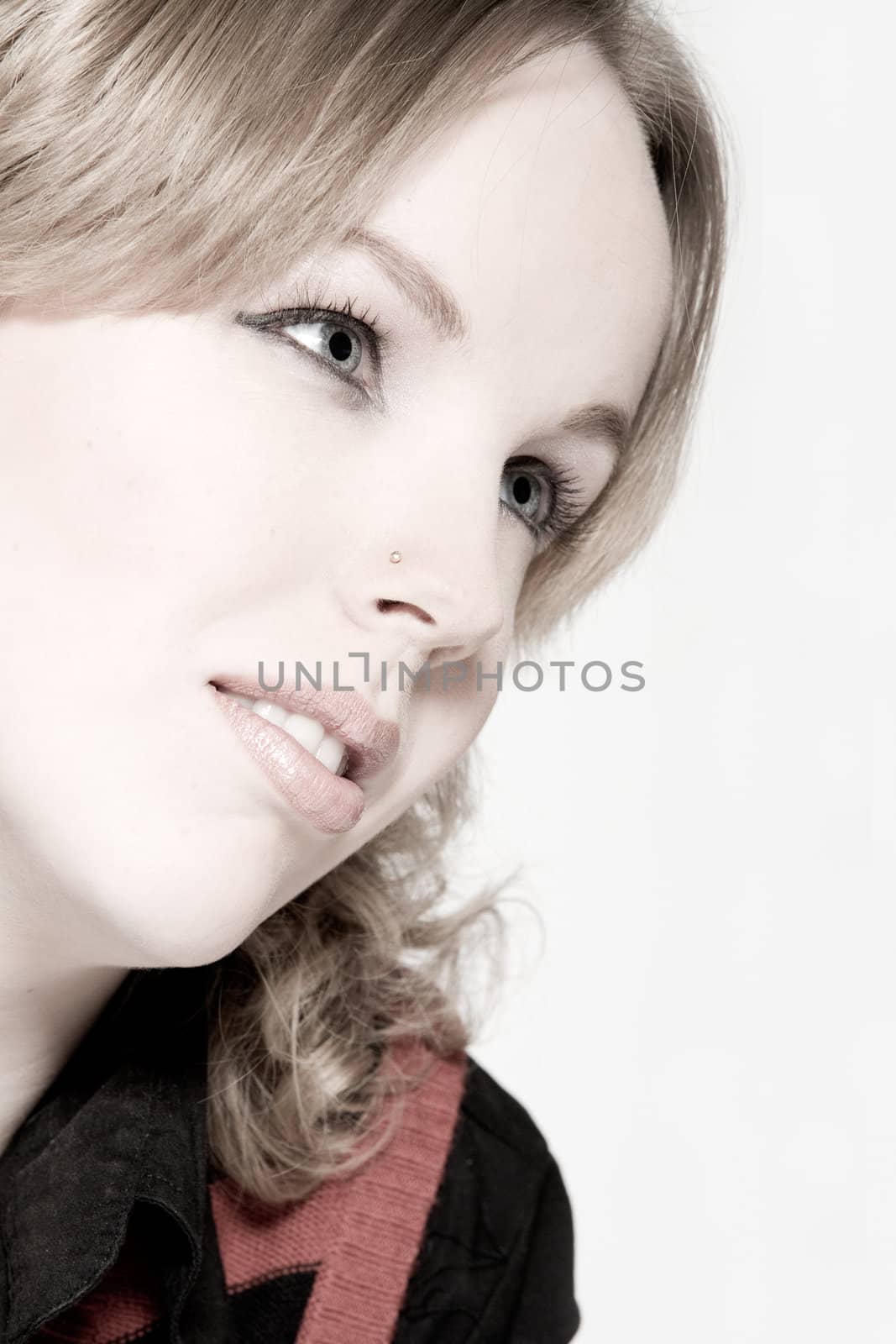 Studio portrait of a young blond curly woman