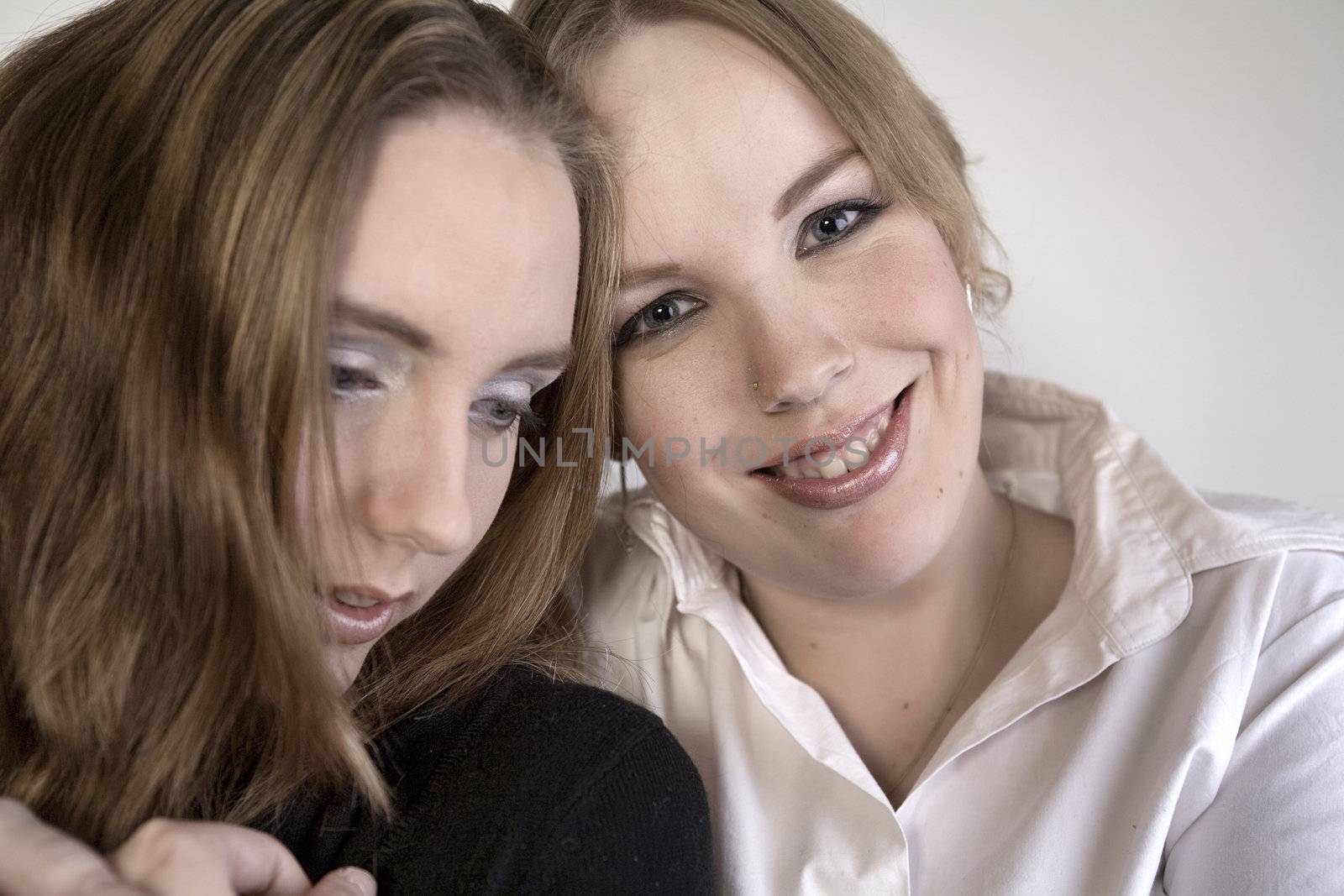 Studio portrait of two lesbian women holding each other
