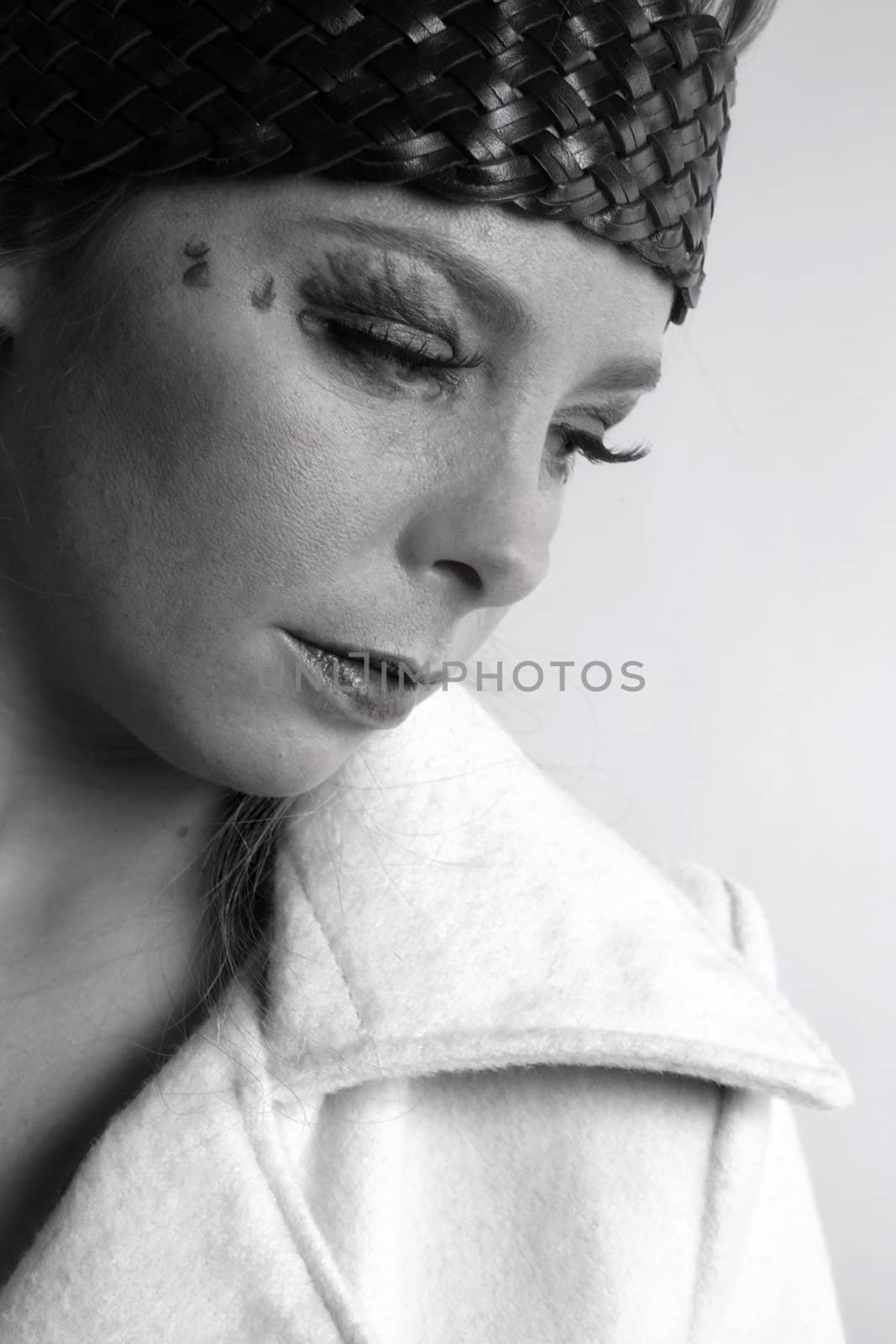 Studio fashion portrait of a young bliond girl looking pensive