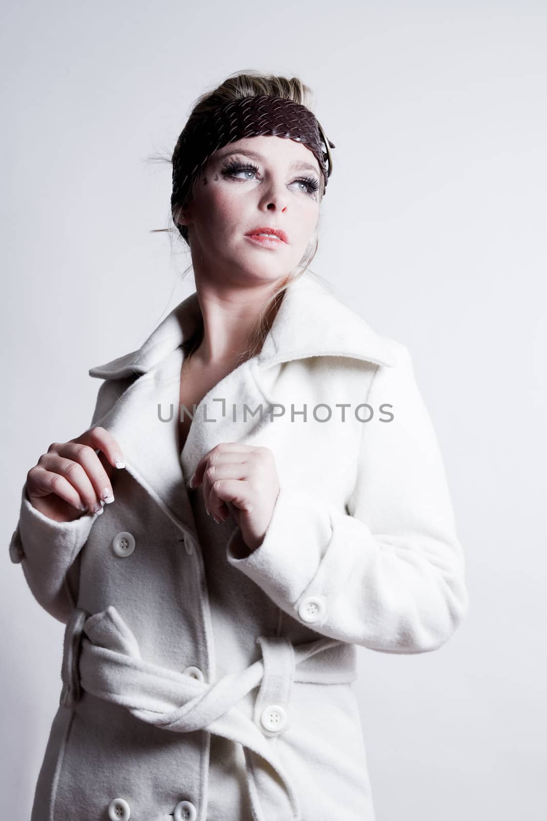 Studio fashion portrait of a young bliond girl with a wool jacket