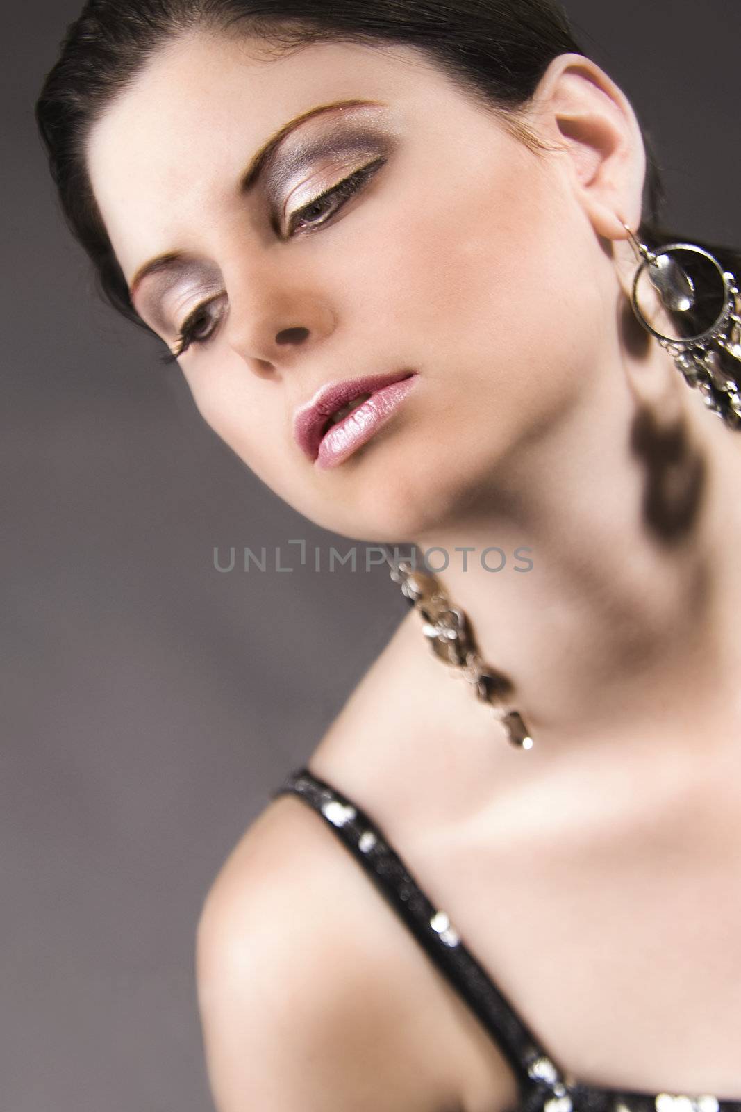 Portrait of a beautiful model showing her earrings