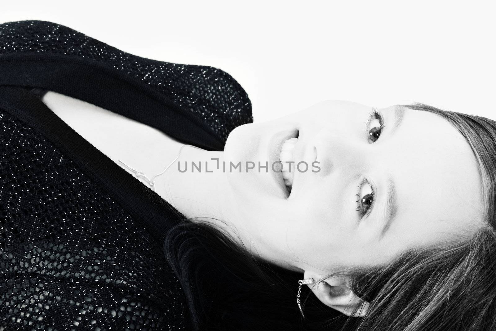Portrait of a beautiful woman model lying on the studio floor
