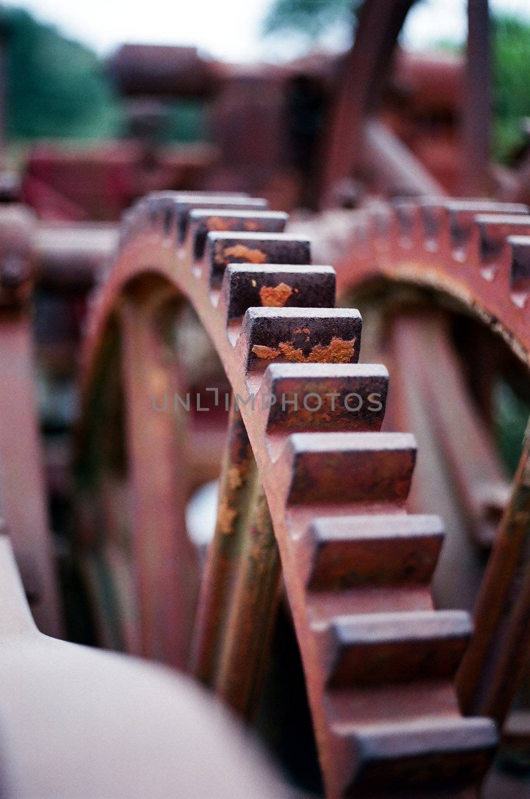 gears on a piece of farm equipment used for harvesting.