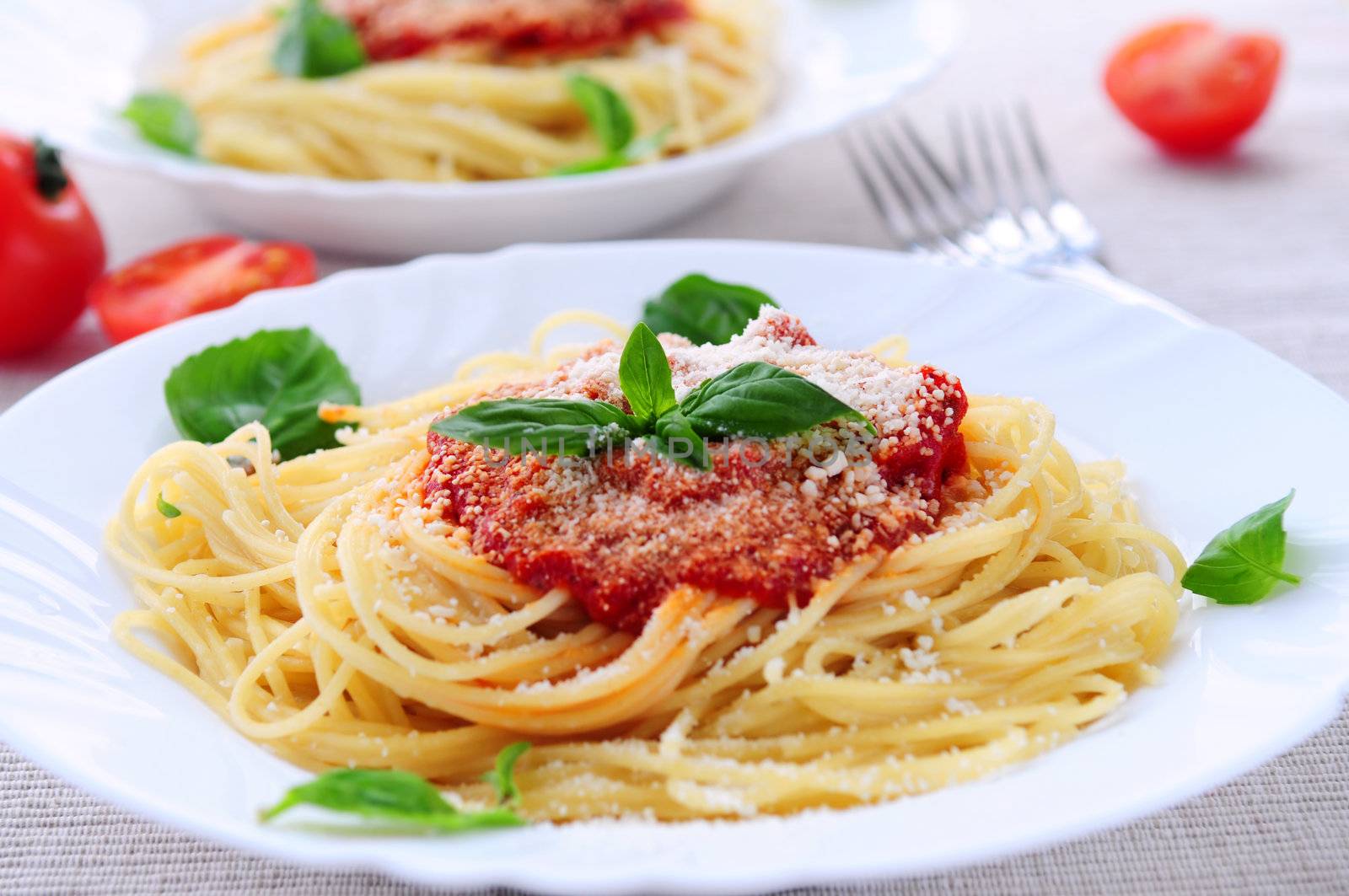 Pasta with tomato sauce basil and grated parmesan