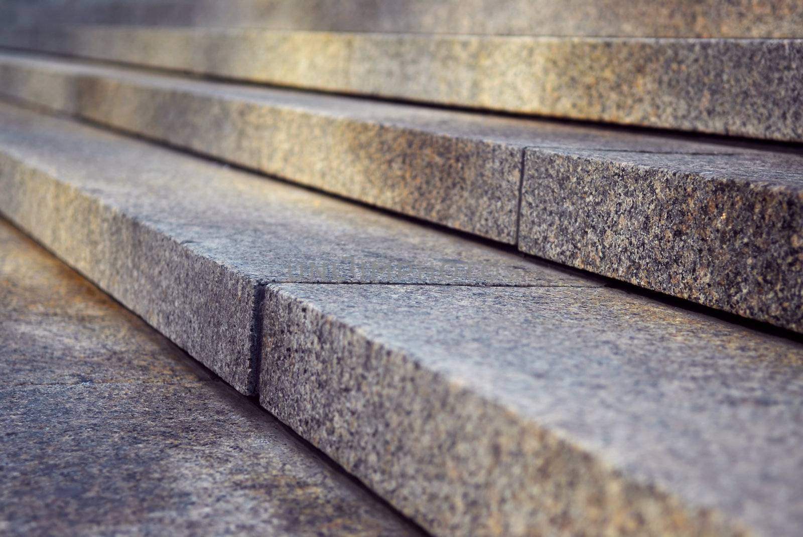 Close up on granite stairs in perspective with sunlight