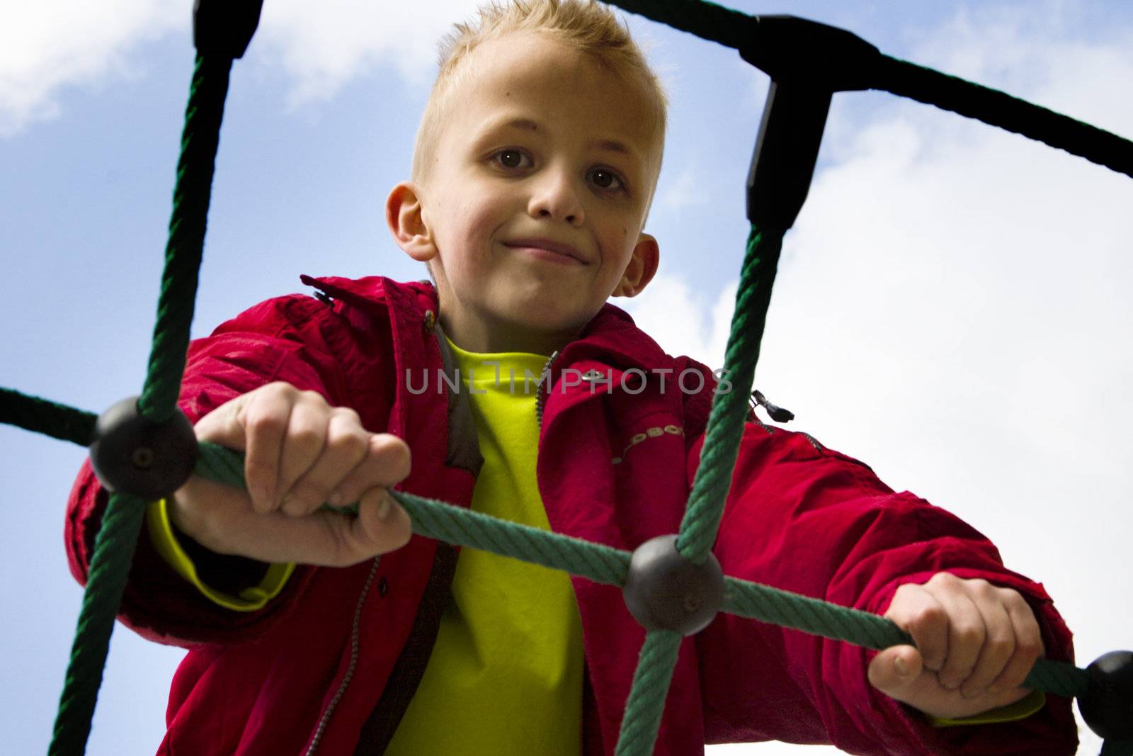 A young boy playing at the playground.