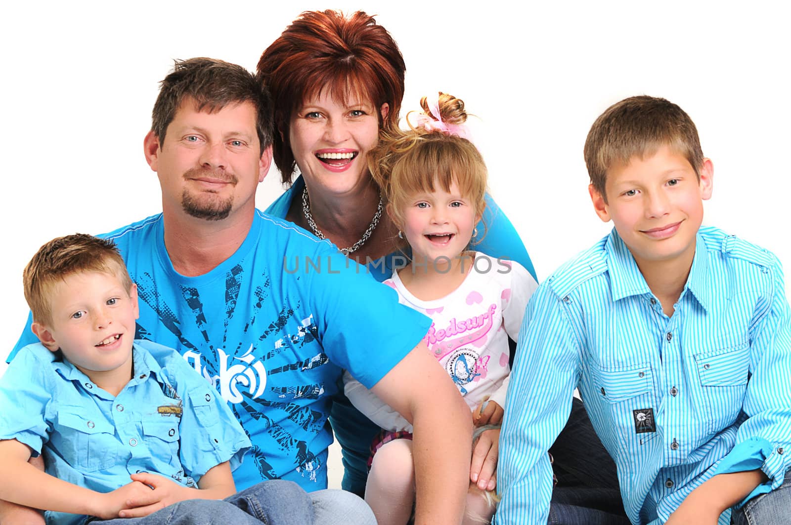 portrait of a happy young family with their sons and and daughter smiling