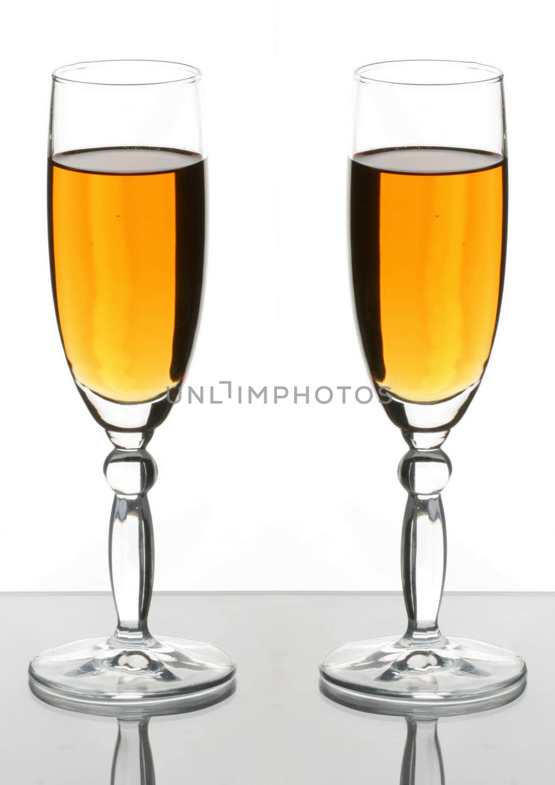 Two wineglass  with white wine on the white background