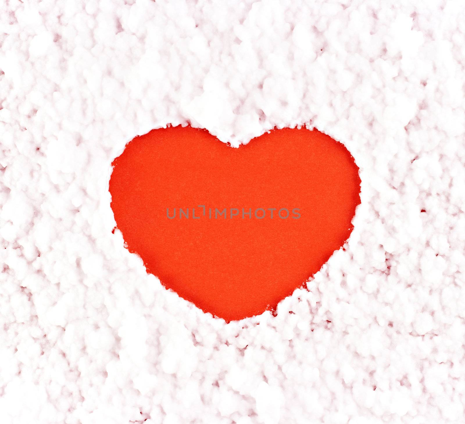 A red heart on the artificial snow background
