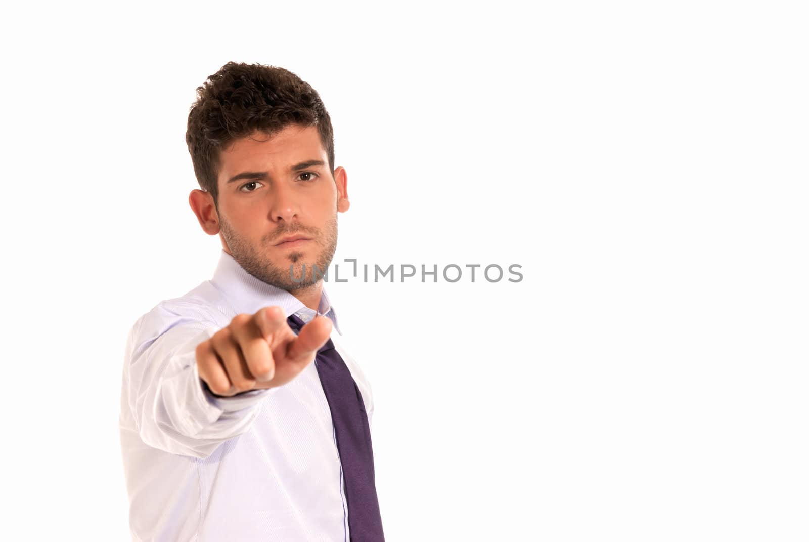 young businessman pointing to camera with copy-space isolated on white background