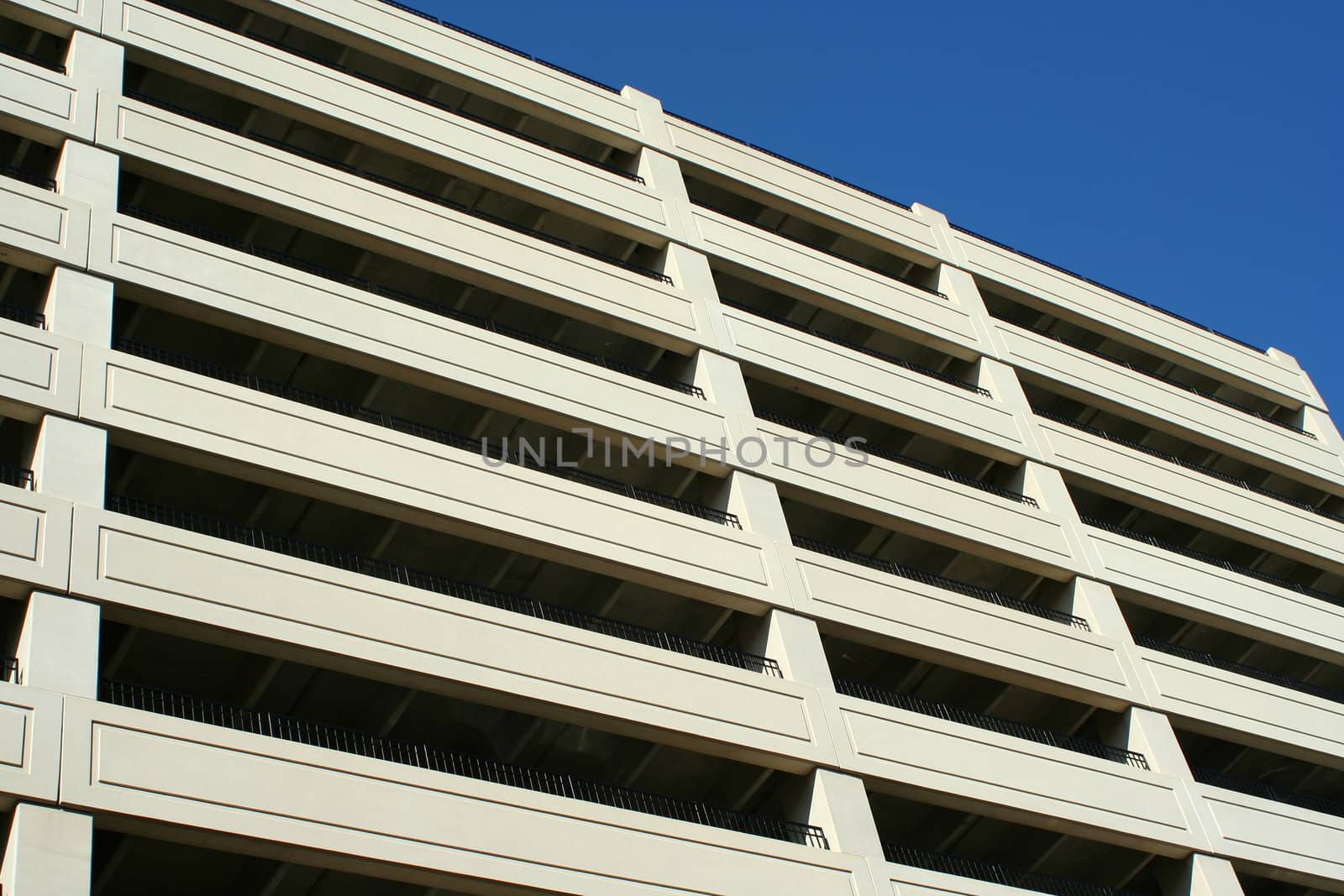 A tall parking deck against blue sky