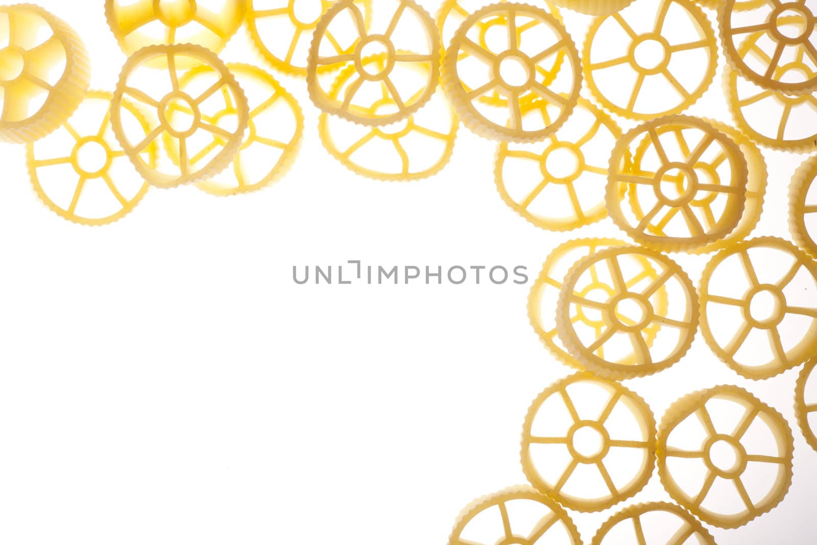 Rotelle pasta on white background with copy space.