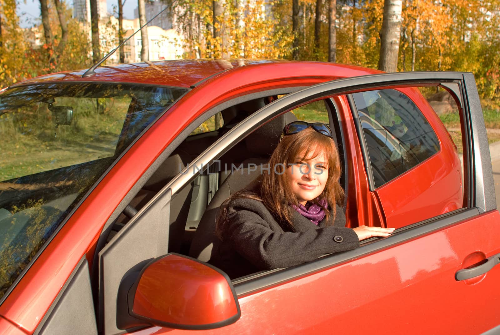 Young women in the cabin of her red car