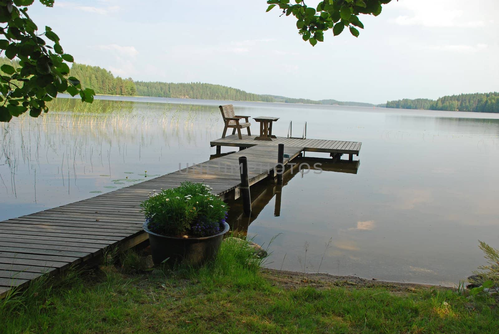 Wooden path in the border of a Lake, for the rest, fishing, swiming,  its very typical atribute of finnich lifestile in Central Finland, there are forests at the background