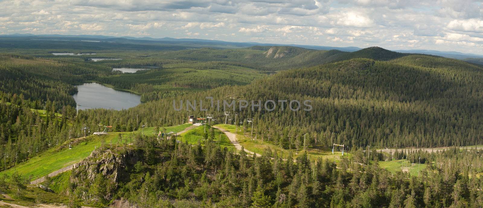 Its a Vew from Ruka ski station, most popular in Finland situated in Kuusamo region. Lakes, hills forests comming to the horizon were is the Russian Karelia, sky is covered with clouds contrasted by evening sun 