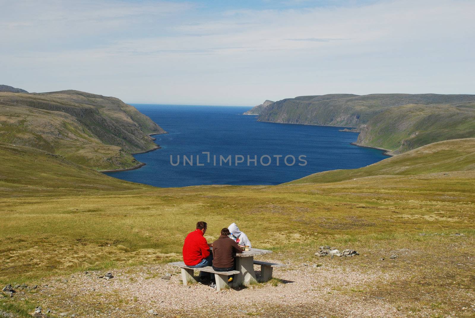 Peoples doing picnic in Mageroya's tundra, in summer time, arctic waters and blue sky are at background, Nordic tourism is sometimes comfortable 