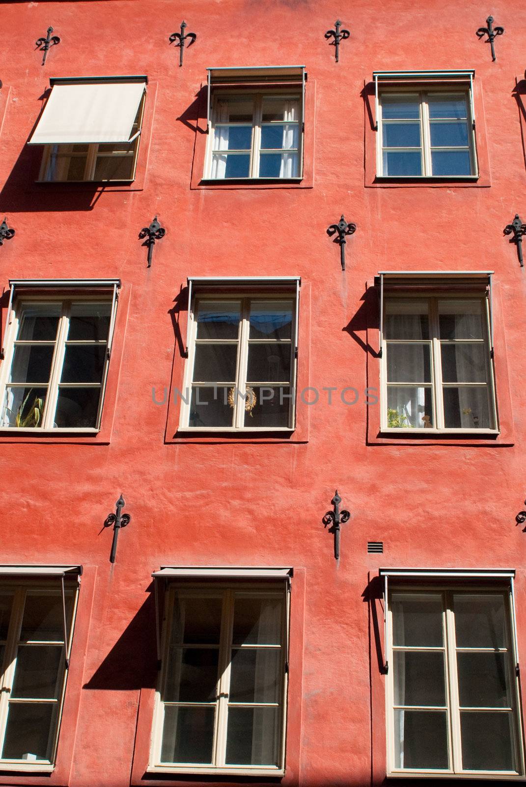 a red painted ancient house with an ornamented facade