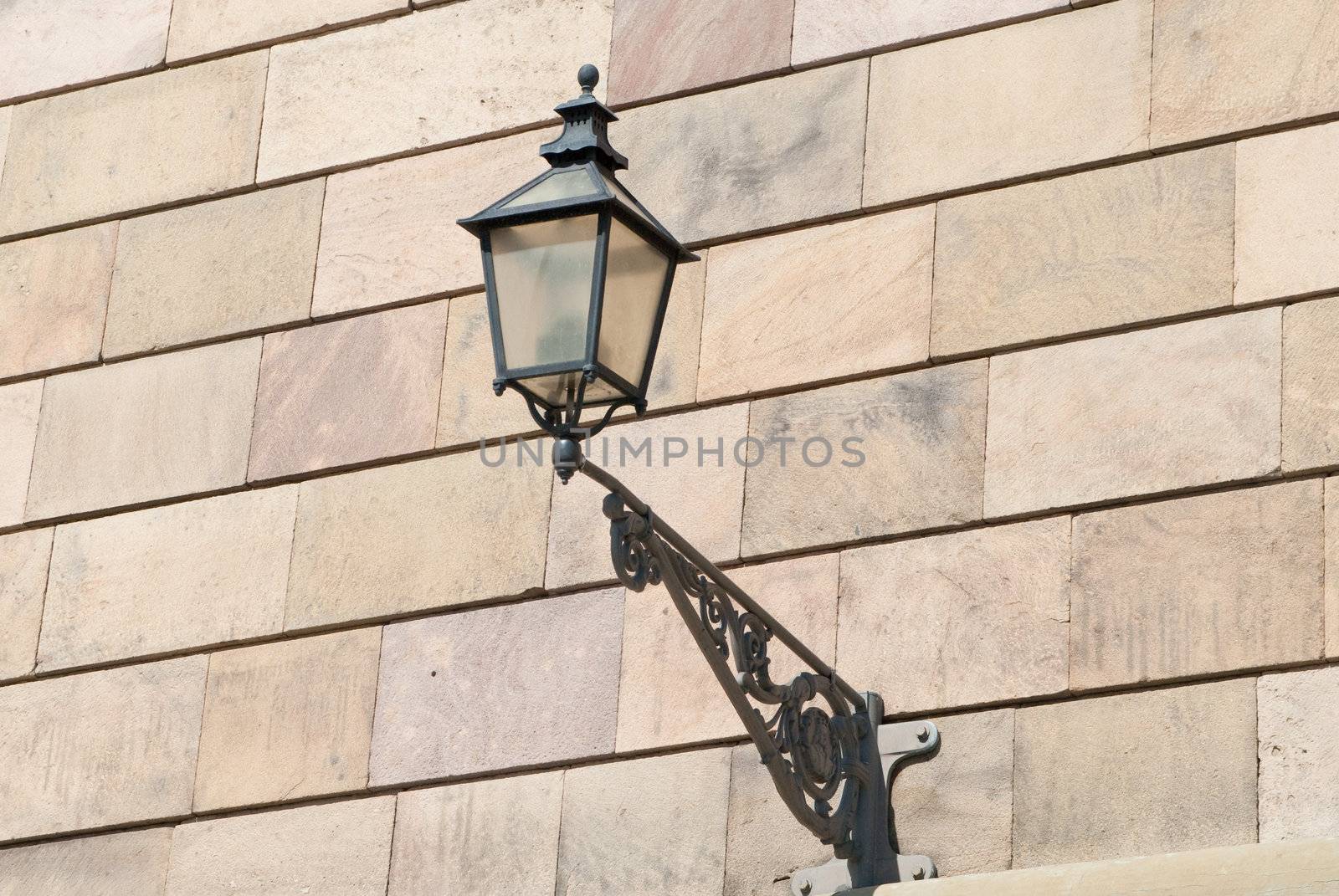 a old lamp on a brick wall in stockholm