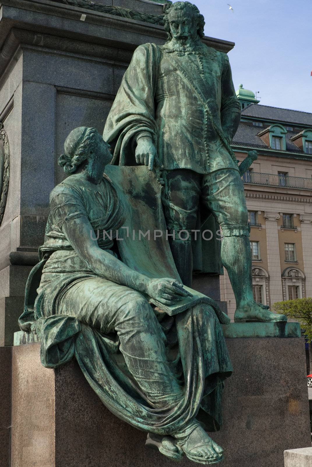 a statue of a man dictating a women to write something down in stockholm