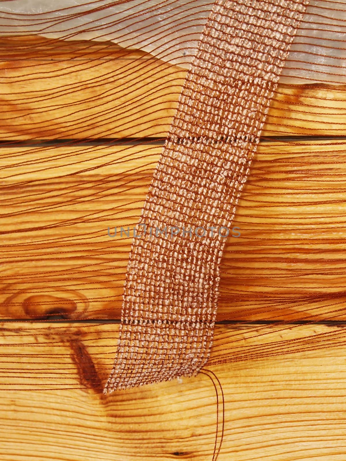 Detail of mesh fabric on the background of varnished wooden surface