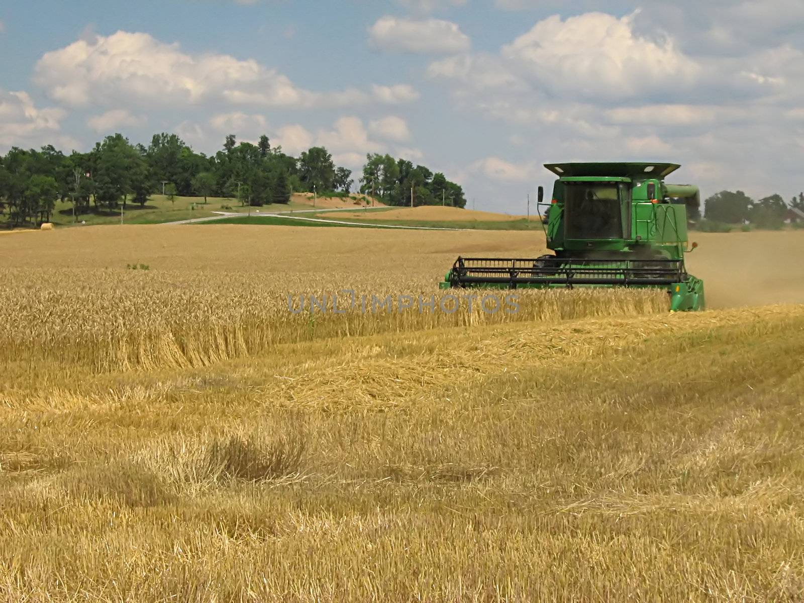 A photograph of a combine harvesting crops.