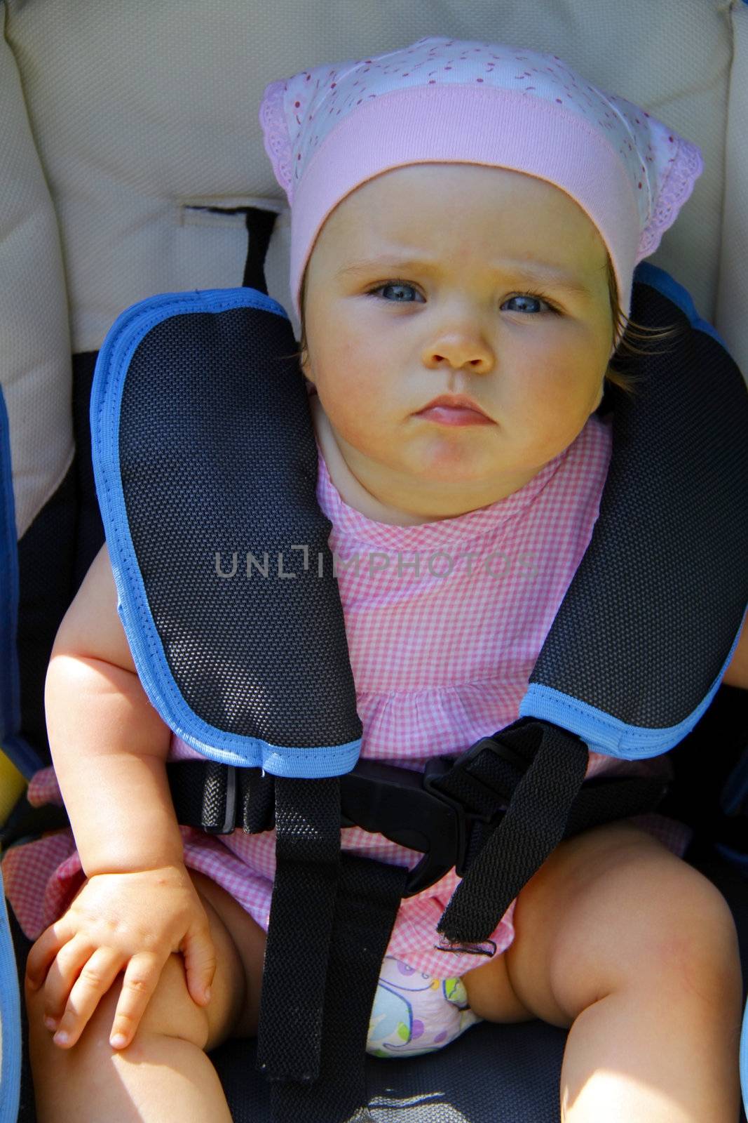 Baby girl in child safety car seat